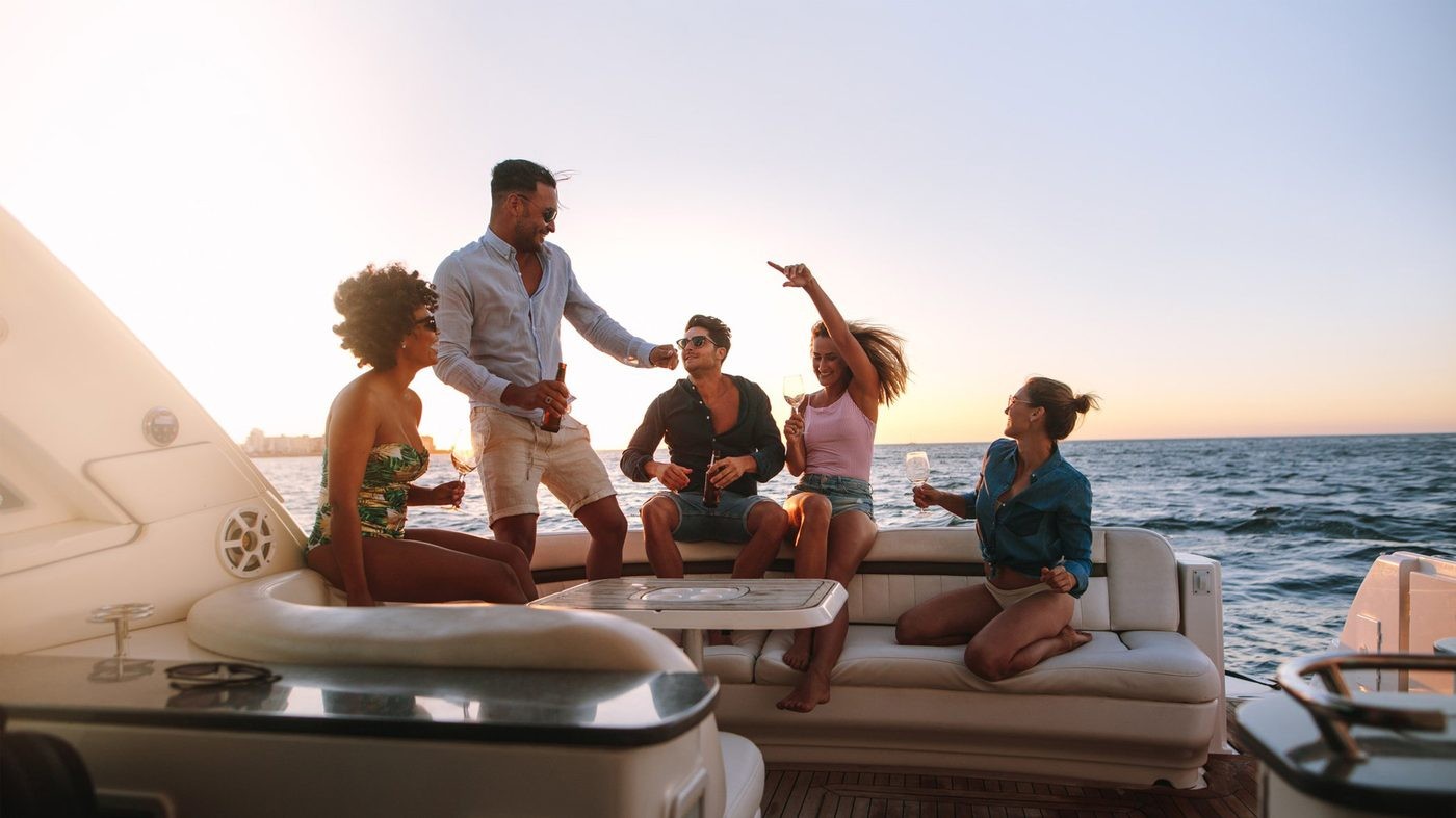 Guests on a private boat at sunset along the Amalfi Coast